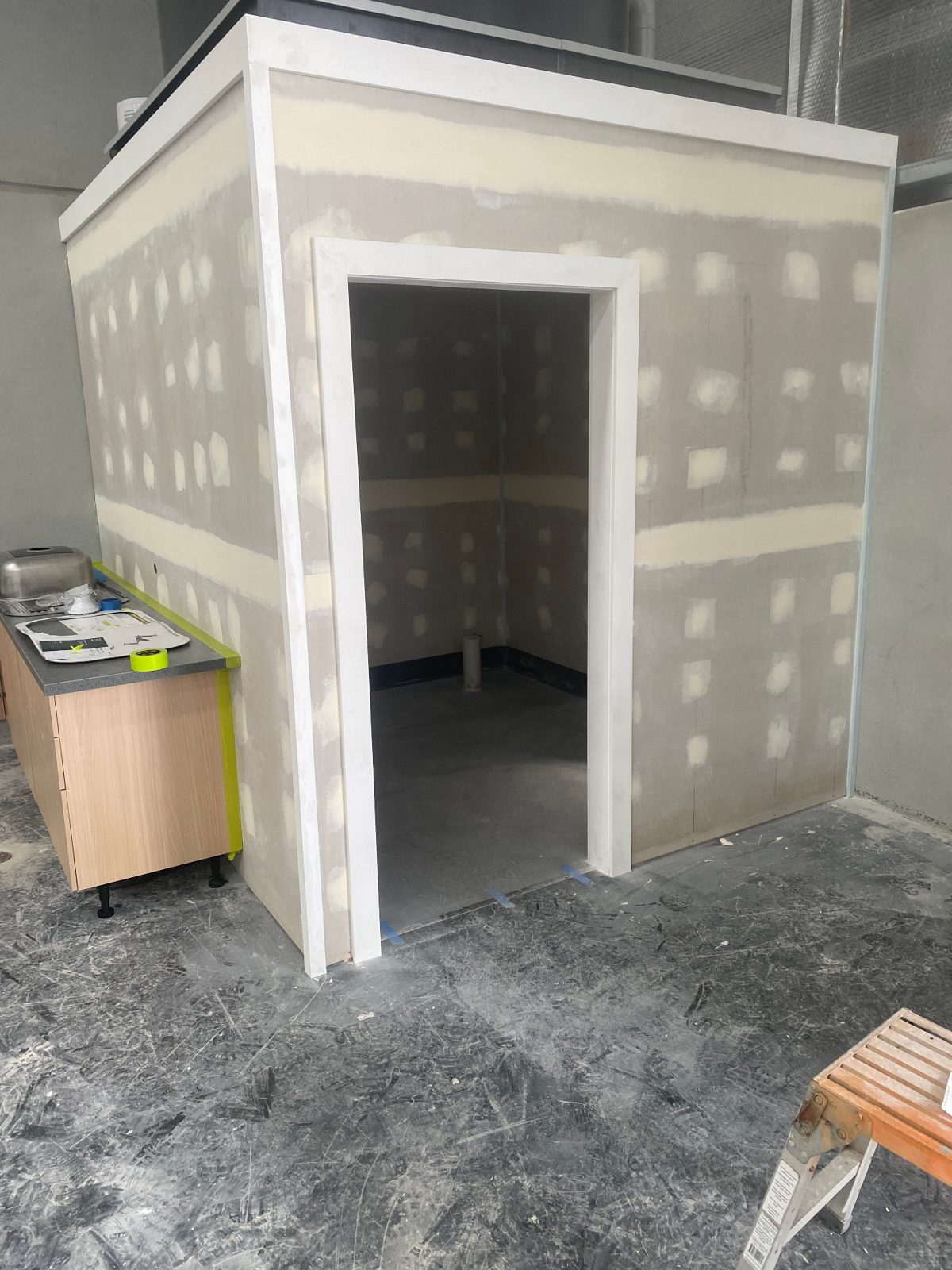 Shed amenities exterior — completed framing and door install
